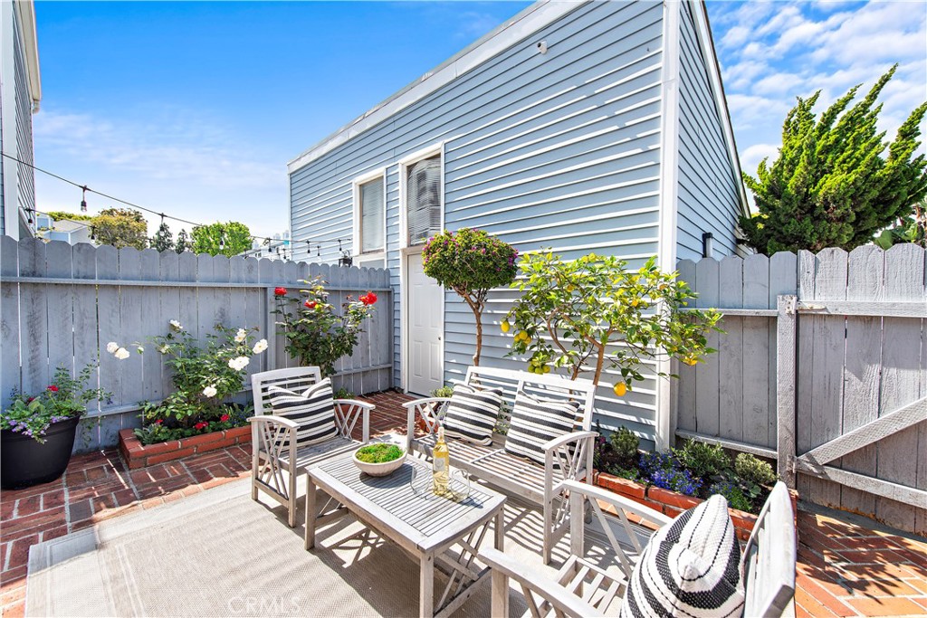 24592 Harbor View Drive, Unit B Dana Point, CA 92629 - Photo 17 of 33 a backyard of a house with dining table and chairs potted plants