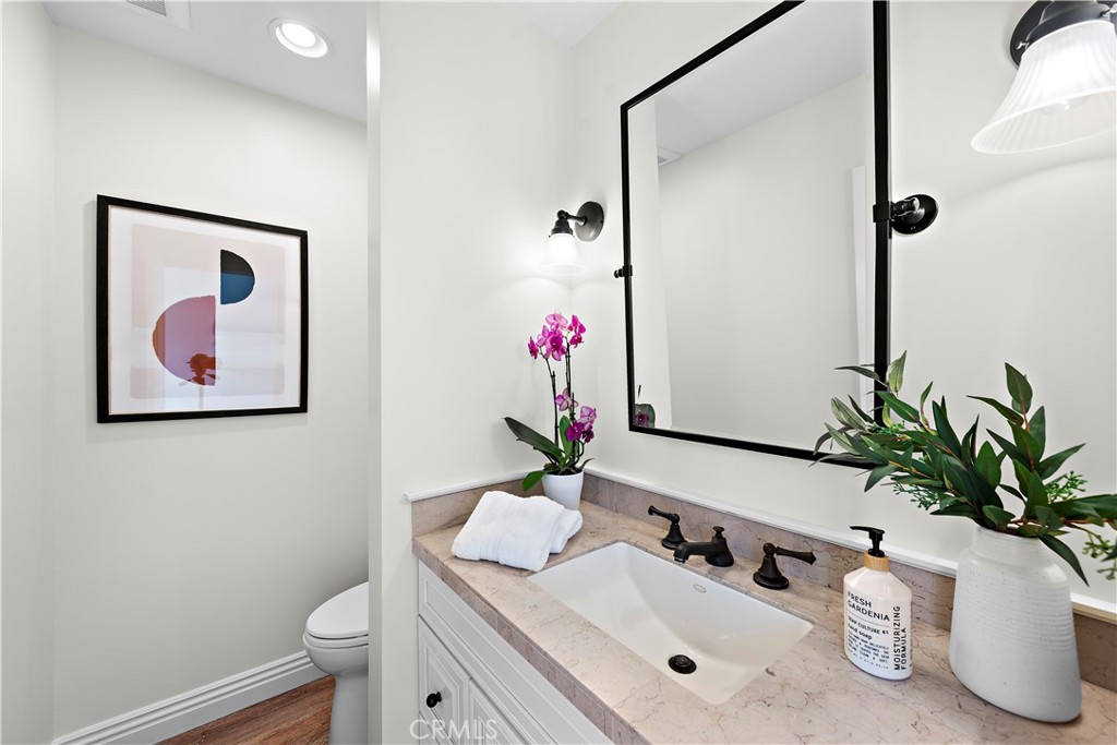 24592 Harbor View Drive, Unit B Dana Point, CA 92629 - Photo 18 of 33 a bathroom with a sink a mirror and a toilet