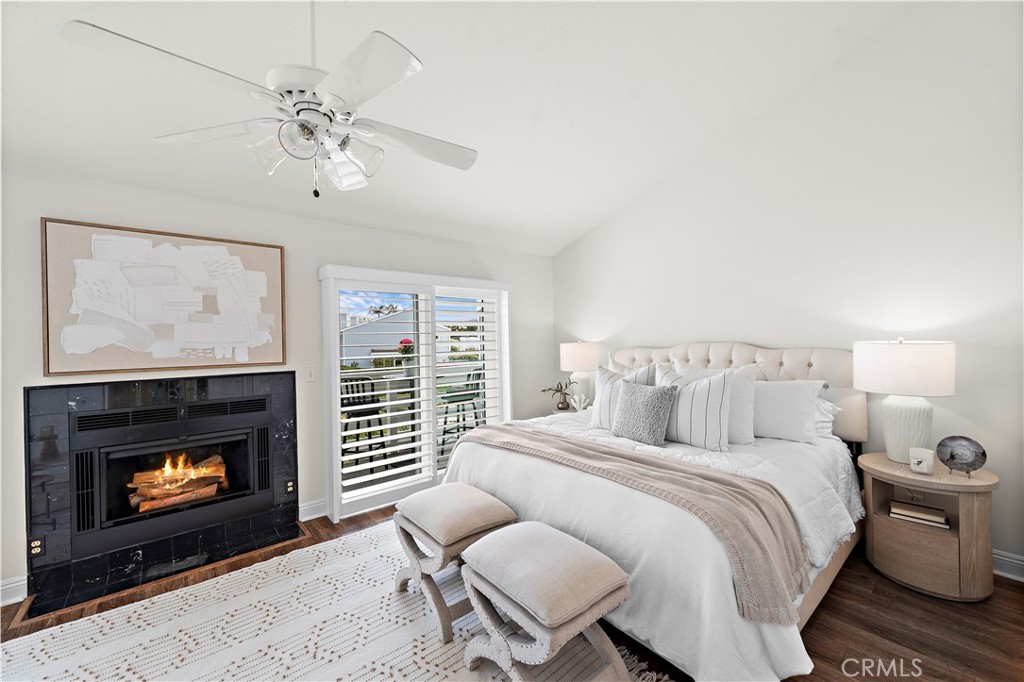 24592 Harbor View Drive, Unit B Dana Point, CA 92629 - Photo 19 of 33 a bedroom with a bed and a fireplace