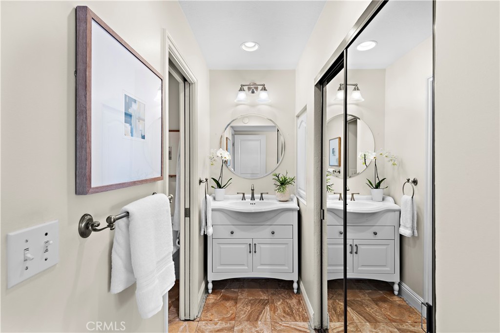 24592 Harbor View Drive, Unit B Dana Point, CA 92629 - Photo 22 of 33 a en suite spacious bathroom with a double vanity sink and mirror