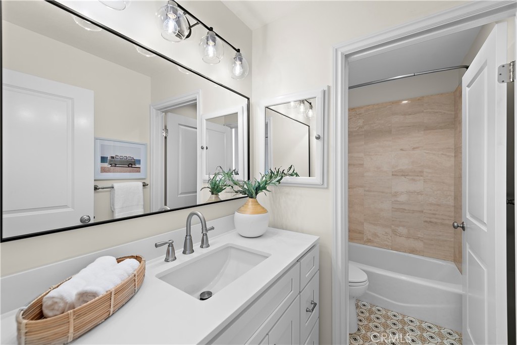 24592 Harbor View Drive, Unit B Dana Point, CA 92629 - Photo 24 of 33 a bathroom with a bathtub shower sink and toilet