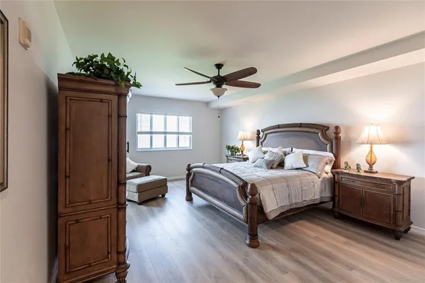 a bedroom with a bed window and a ceiling fan