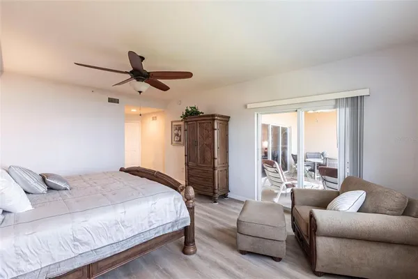 a bedroom with a large bed couch and a window