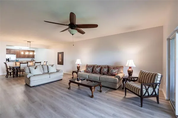 a living room with furniture and a wooden floor