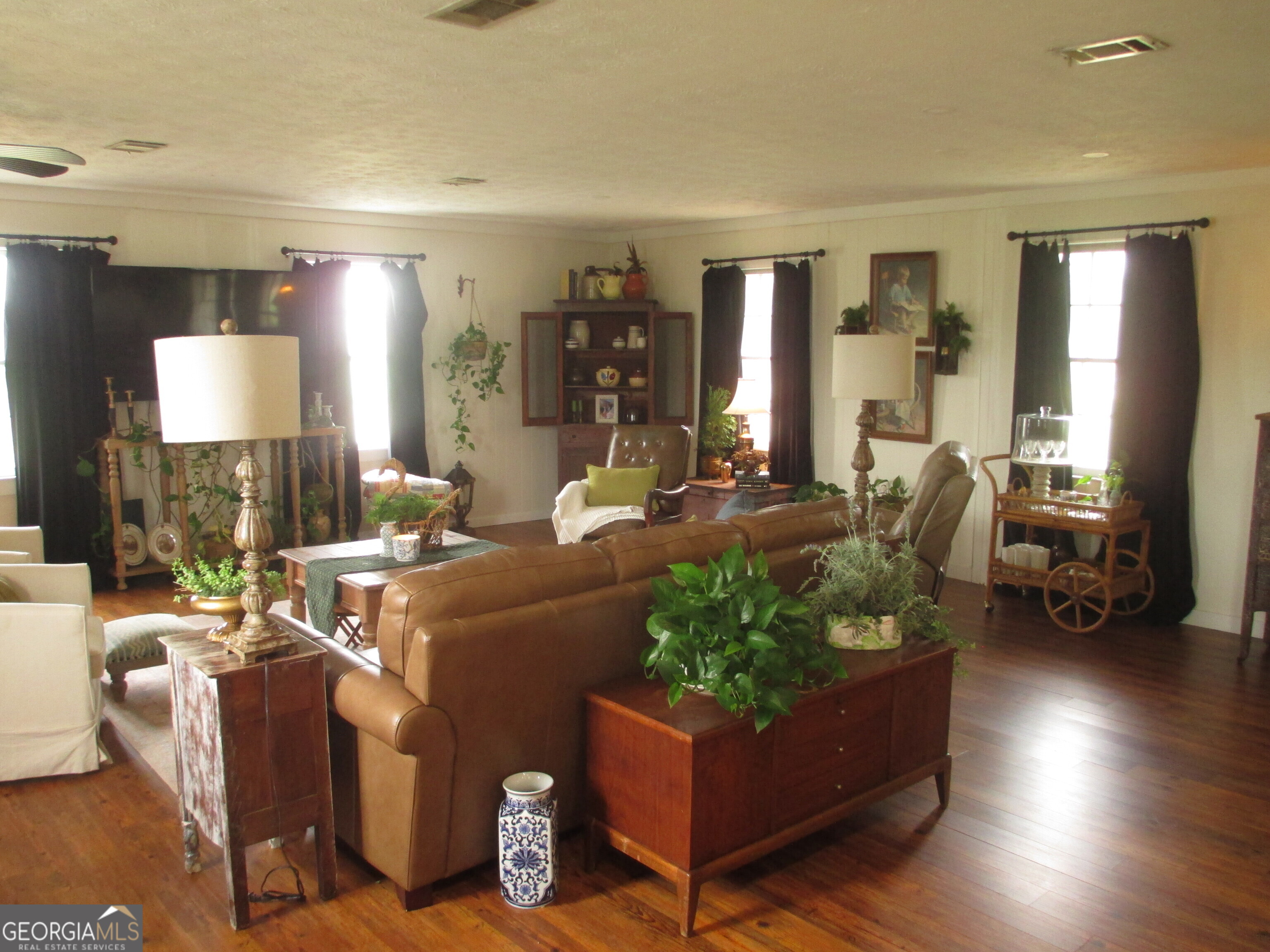 84 Comer Yawn Road Hazlehurst, GA 31539 - Photo 16 of 24 a living room with furniture and a wooden floor