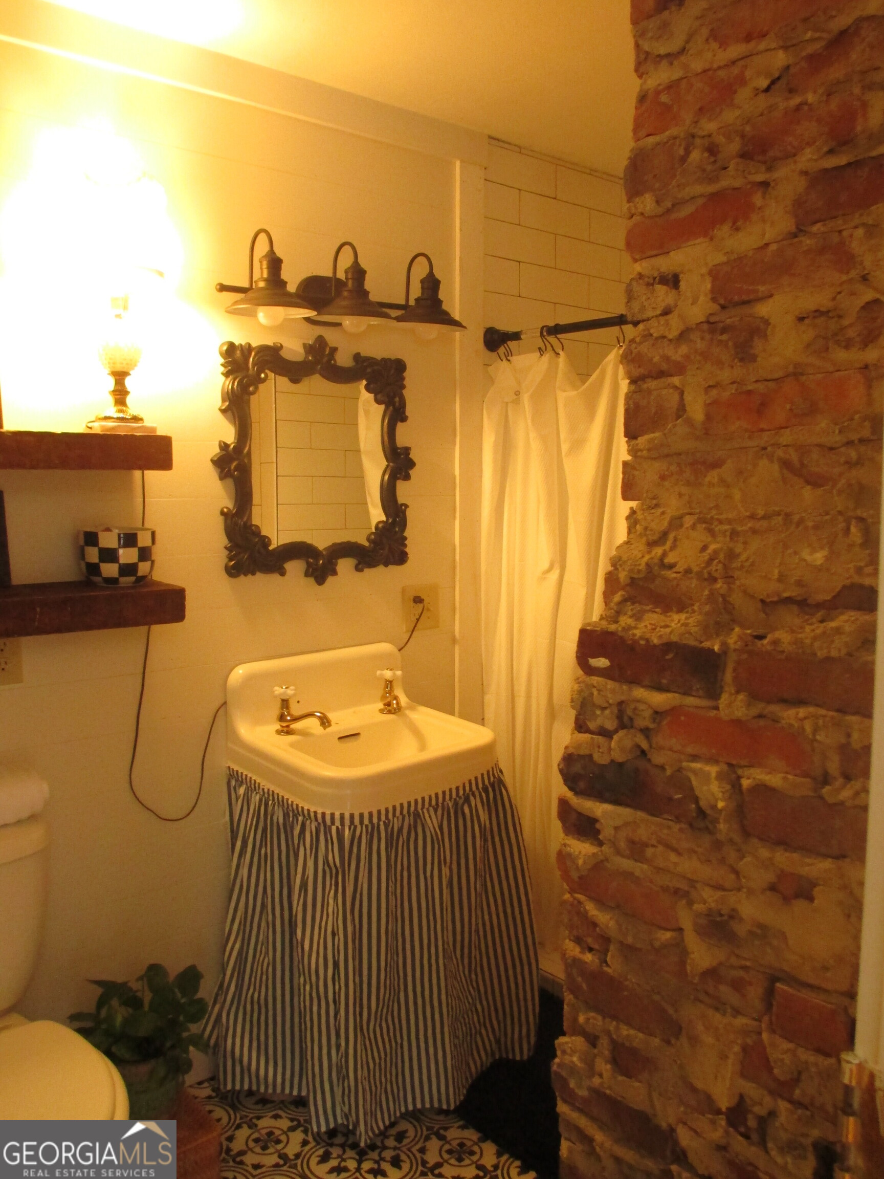 84 Comer Yawn Road Hazlehurst, GA 31539 - Photo 20 of 24 a bathroom with a sink and a mirror