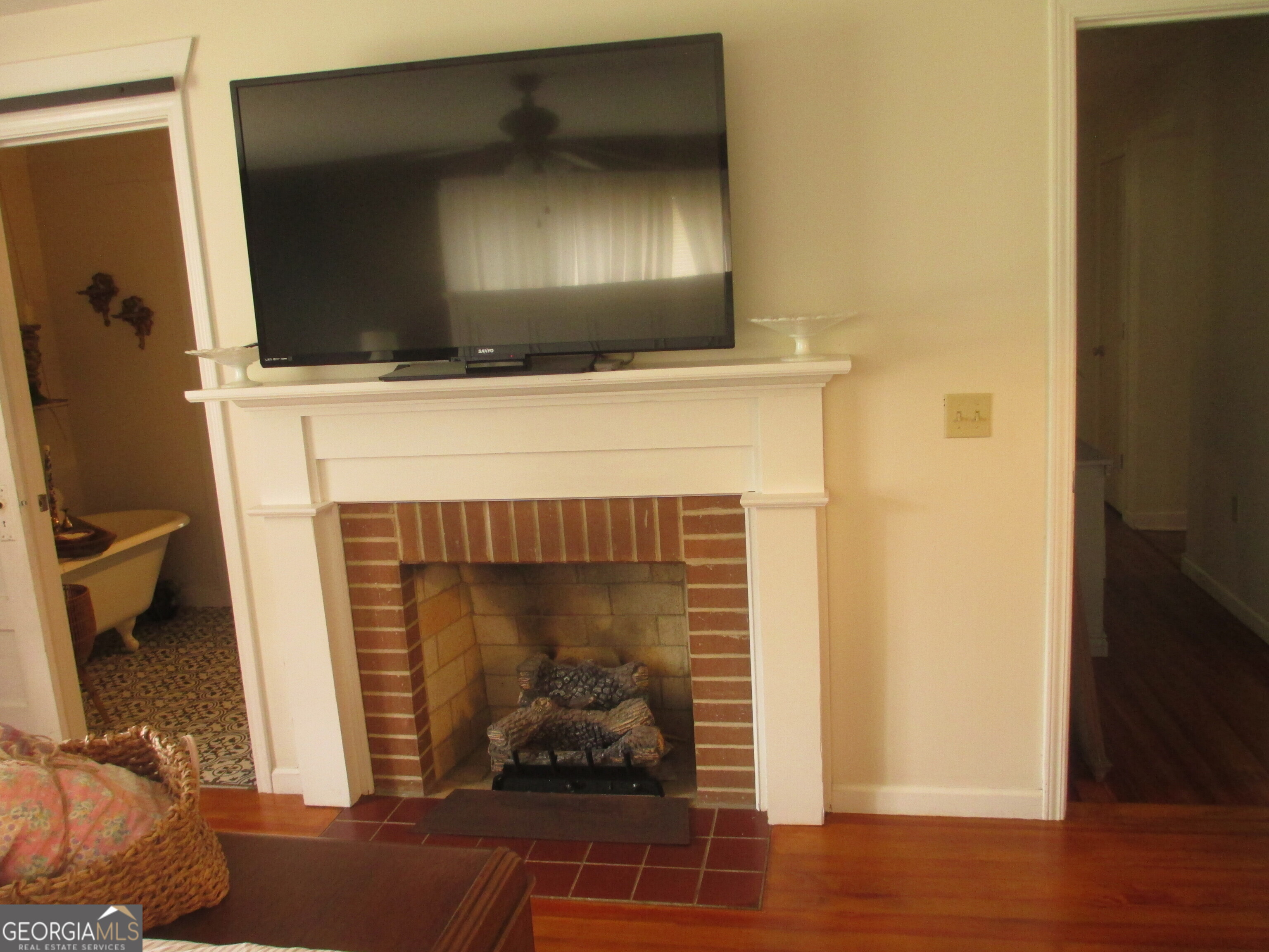 84 Comer Yawn Road Hazlehurst, GA 31539 - Photo 22 of 24 a living room with a fireplace and a flat screen tv