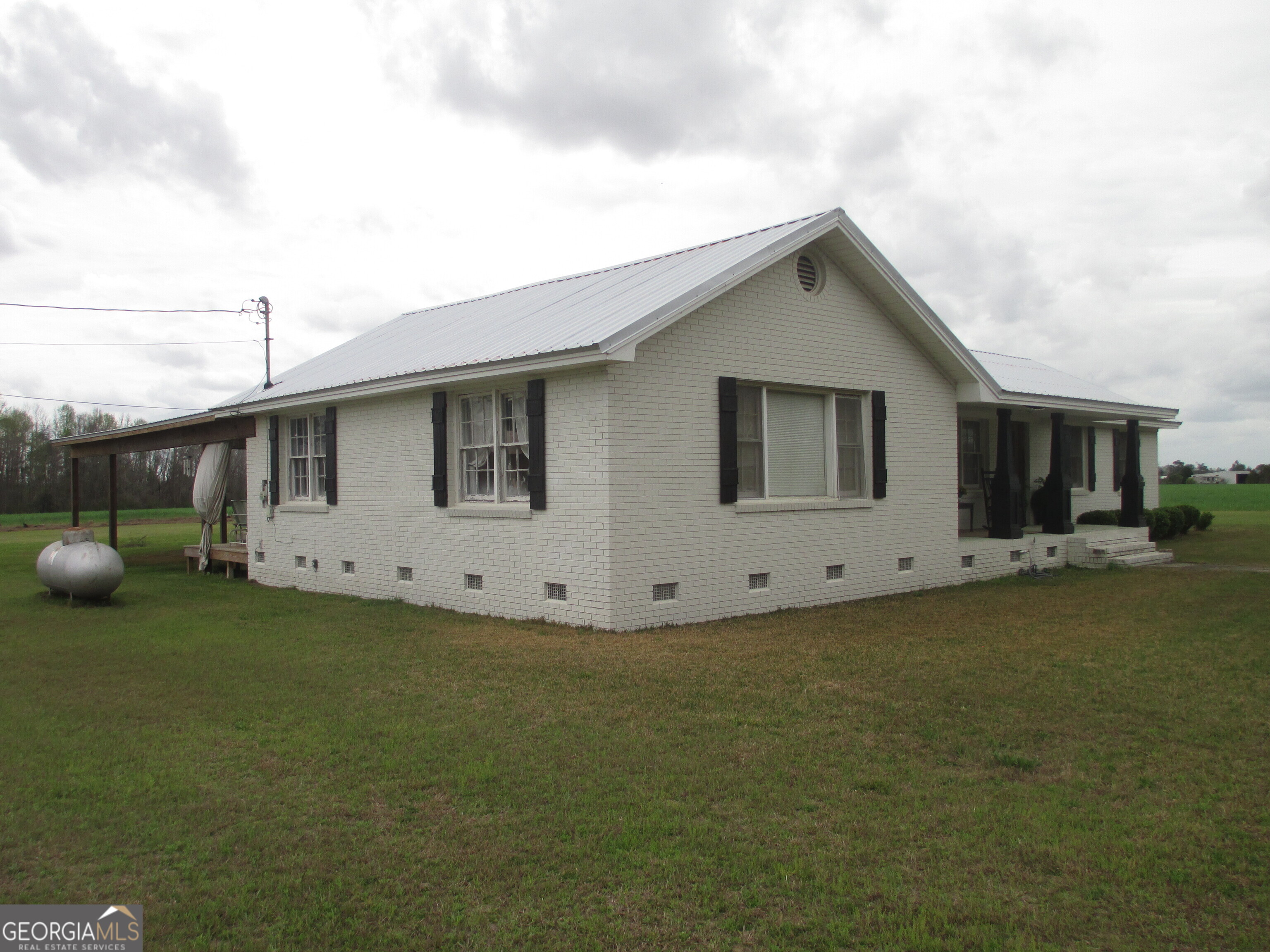 84 Comer Yawn Road Hazlehurst, GA 31539 - Photo 4 of 24 a view of a house with backyard