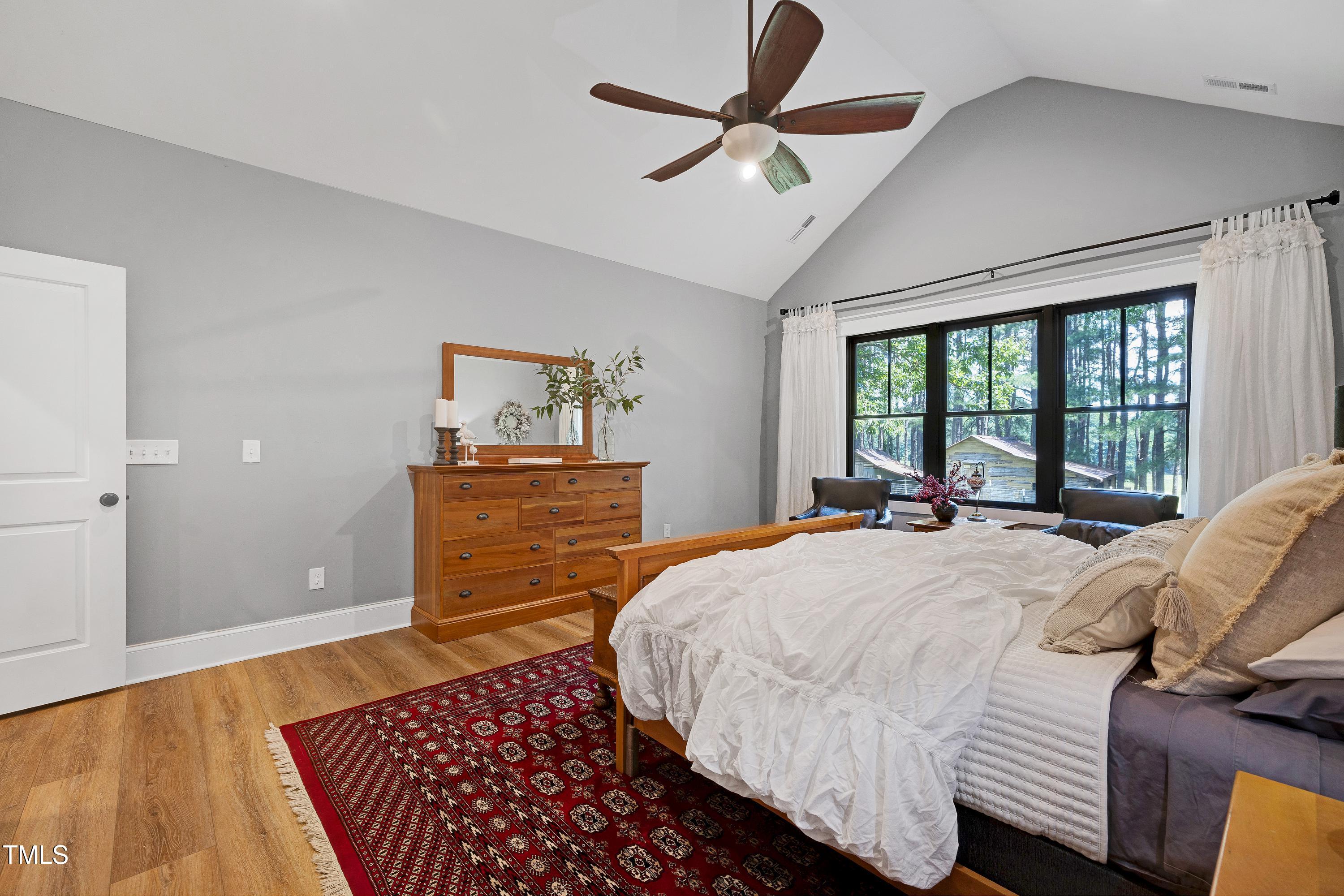 5859 Vicksboro Road Henderson, NC 27537 - Photo 32 of 65 a bedroom with a bed and wooden floor
