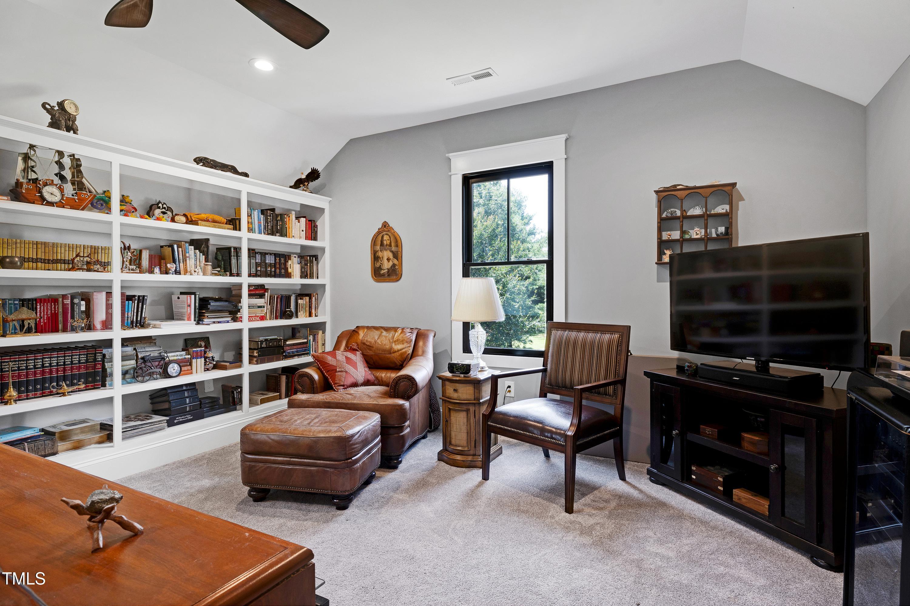 5859 Vicksboro Road Henderson, NC 27537 - Photo 46 of 65 a living room with furniture cabinets and a window