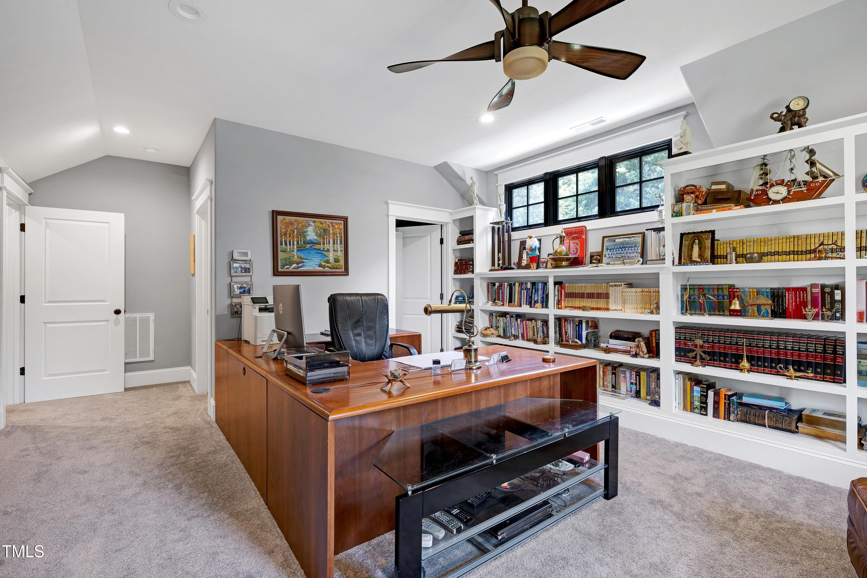 5859 Vicksboro Road Henderson, NC 27537 - Photo 47 of 65 a view of a workspace with bookshelf