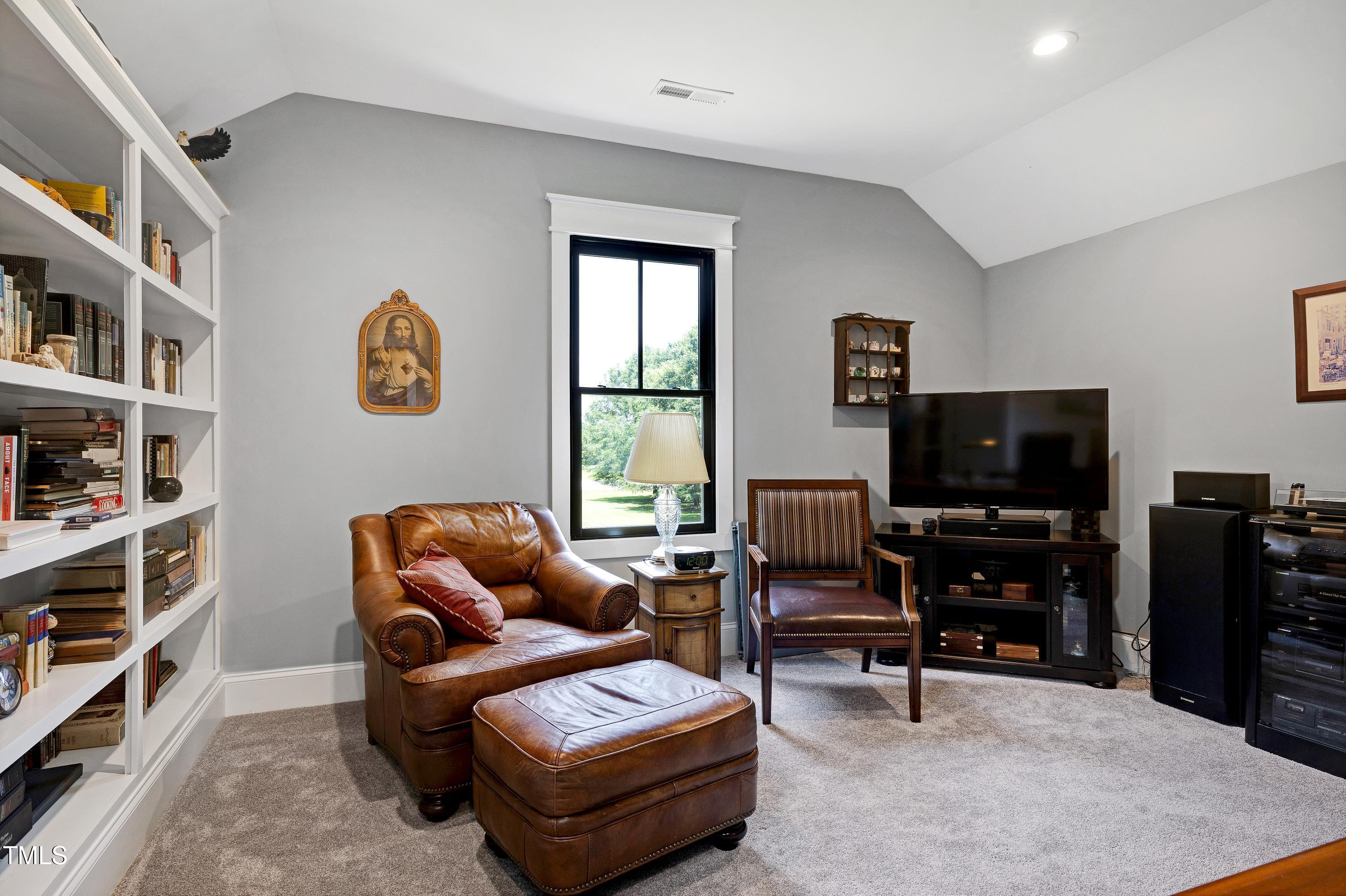 5859 Vicksboro Road Henderson, NC 27537 - Photo 48 of 65 a living room with furniture and a flat screen tv