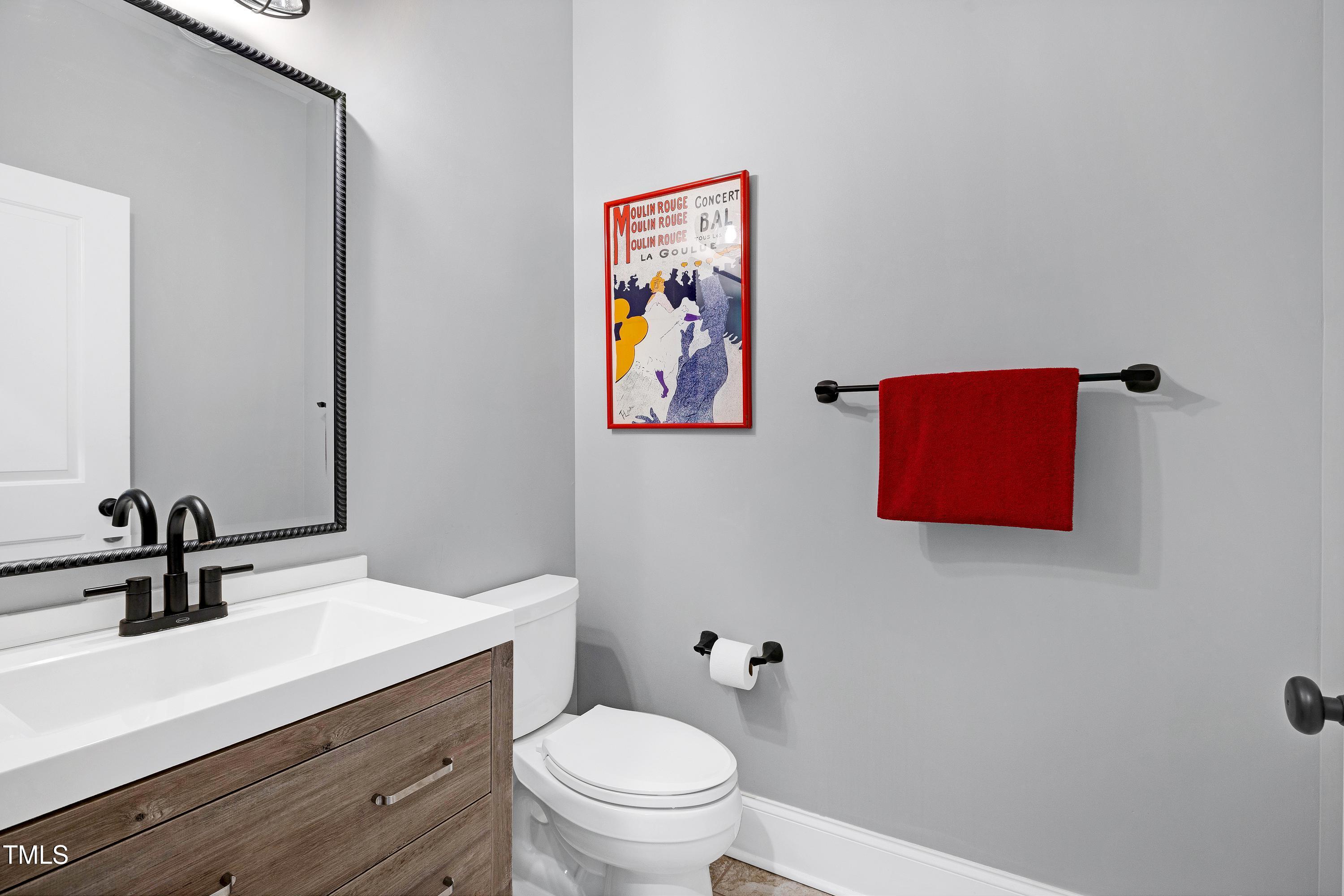 5859 Vicksboro Road Henderson, NC 27537 - Photo 49 of 65 a bathroom with a sink a toilet and mirror