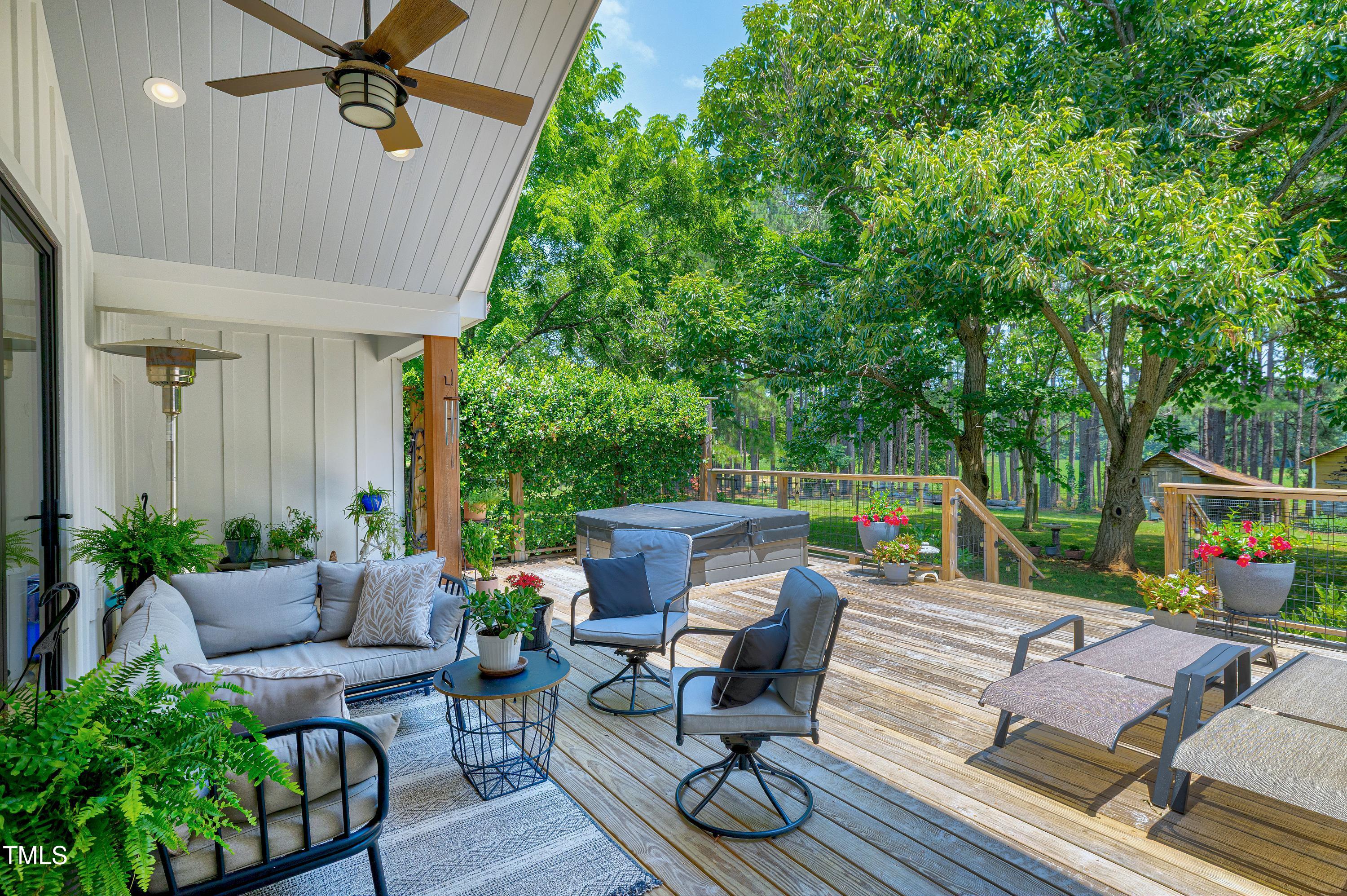 5859 Vicksboro Road Henderson, NC 27537 - Photo 56 of 65 a view of a patio with couches chairs and a potted plant