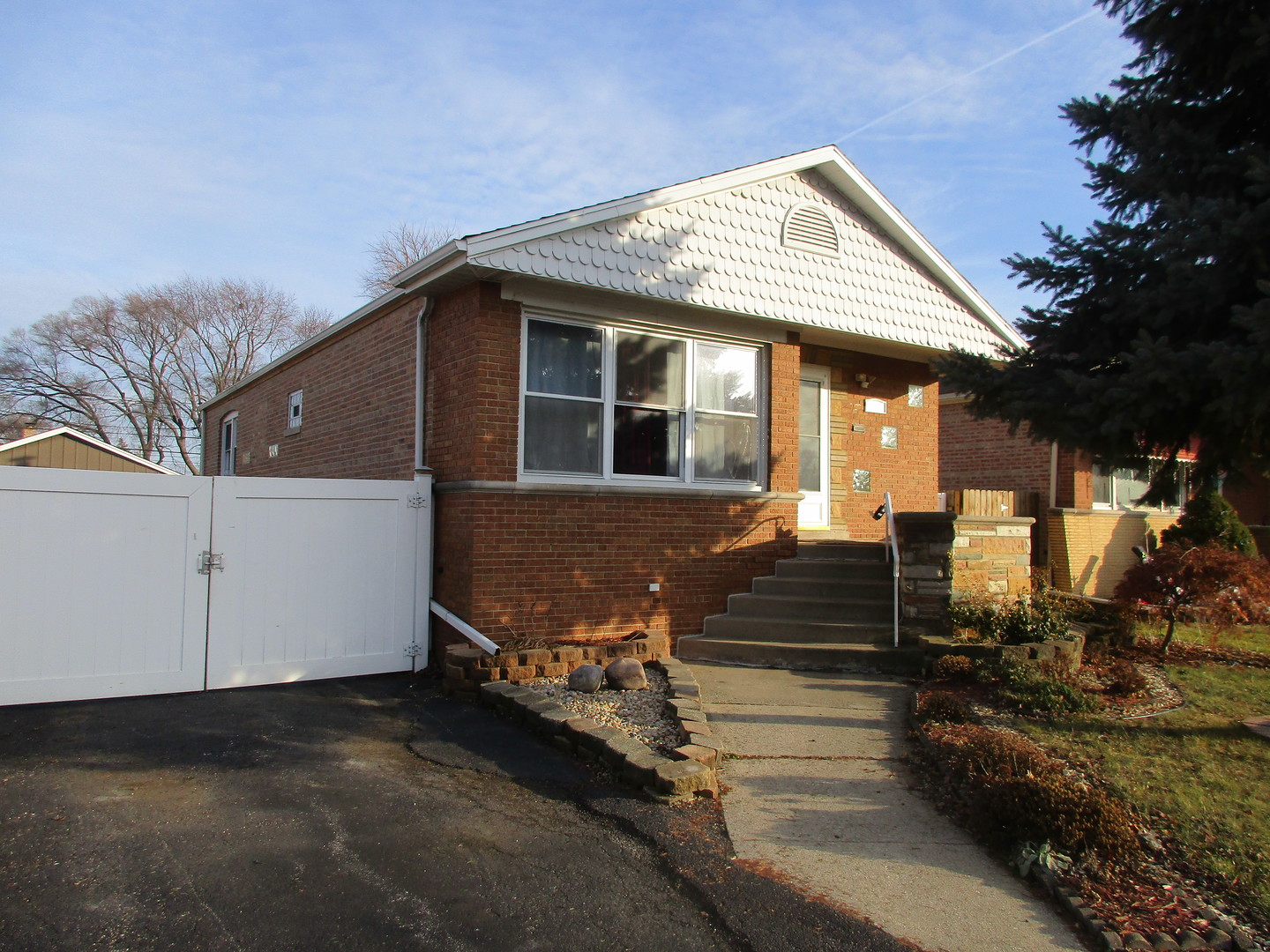 10421 South Tripp Avenue Oak Lawn, IL 60453 - Photo 1 of 29 a front view of a house with a garden