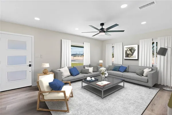 a living room with furniture and wooden floor