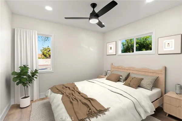 a bedroom with a bed and a potted plant