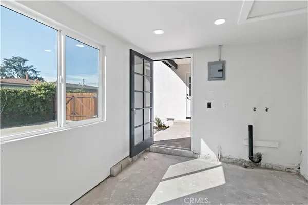 a view of an entryway with wooden floor and door