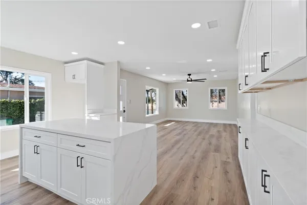 a spacious bathroom with a granite countertop sink a mirror and a shower