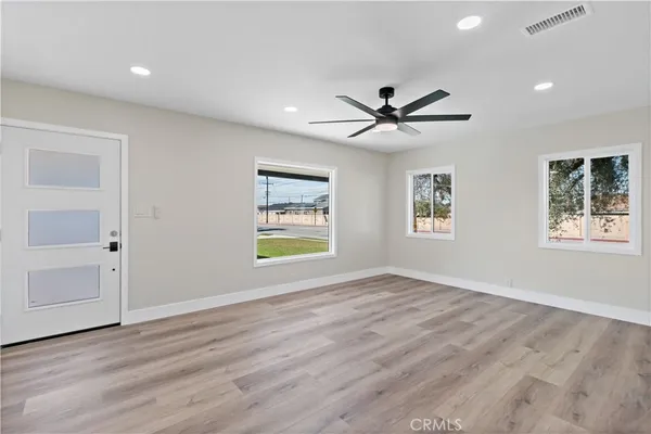 wooden floor in an empty room with a window