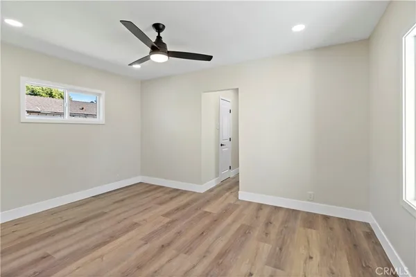 a view of empty room with wooden floor
