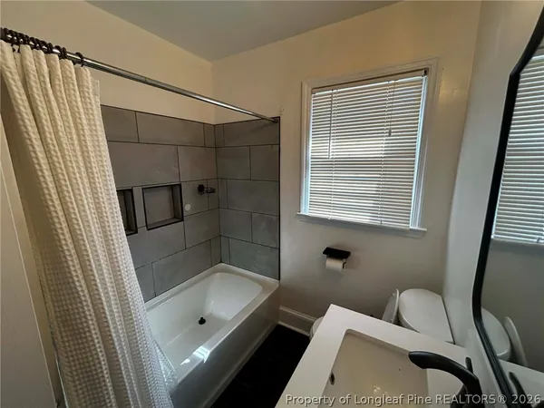 a bathroom with a tub toilet and sink