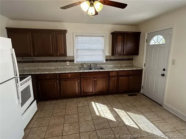 a kitchen with stainless steel appliances granite countertop a sink and cabinets