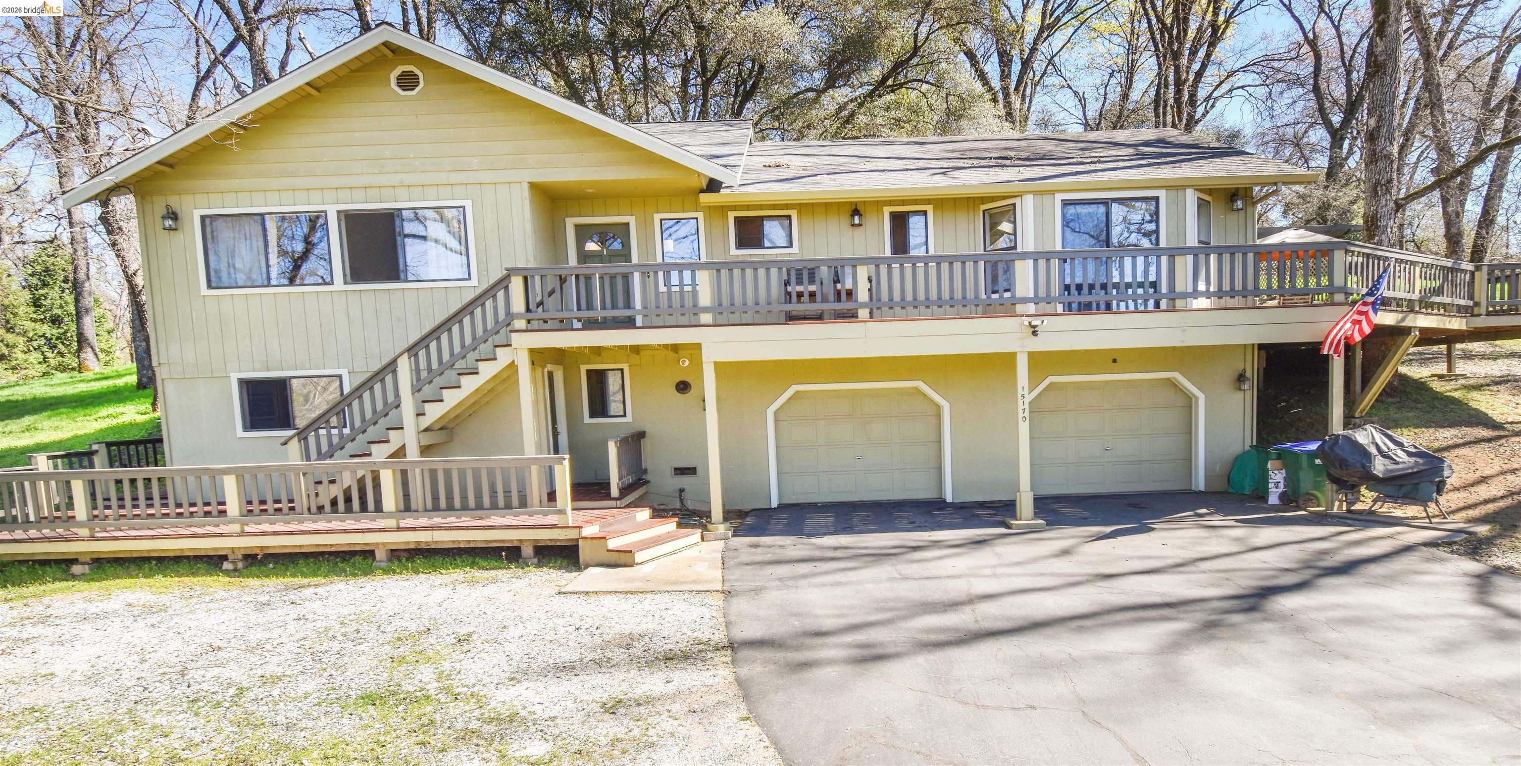 15170 Potato Ranch Road Sonora, CA 95370 - Photo 2 of 49 Chalet / cabin featuring a deck, driveway, and an attached garage