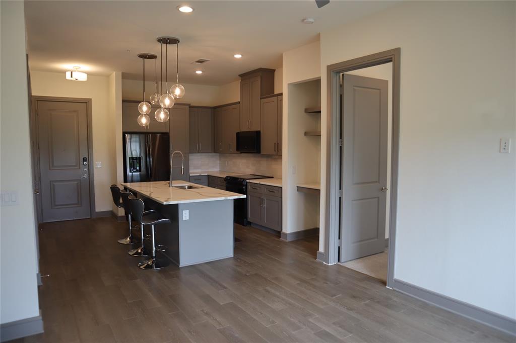 2700 Old Denton Road, Unit 3314 Carrollton, TX 75007 - Photo 6 of 14 a large kitchen with a table and chairs