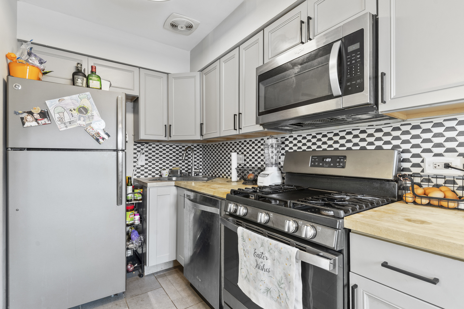 400 North Addison Road Villa Park, IL 60181 - Photo 7 of 21 a kitchen with stainless steel appliances granite countertop a stove and a microwave