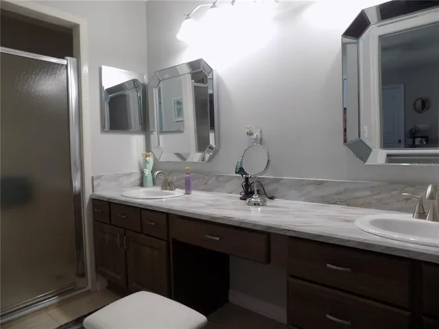 a bathroom with a double vanity sink and a mirror