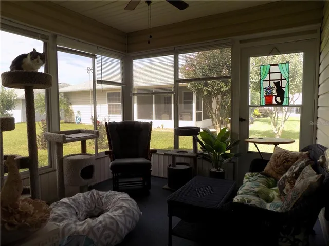 a living room with furniture and a floor to ceiling window