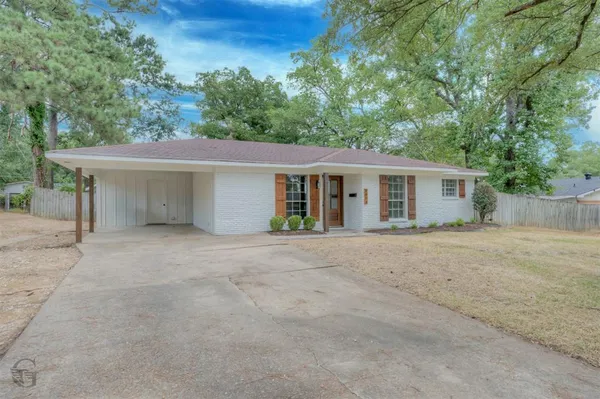 front view of a house with a yard and a garage