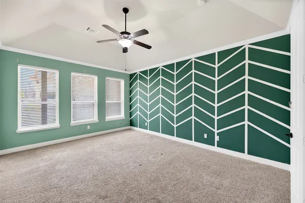 a view of an empty room with a window and a ceiling fan