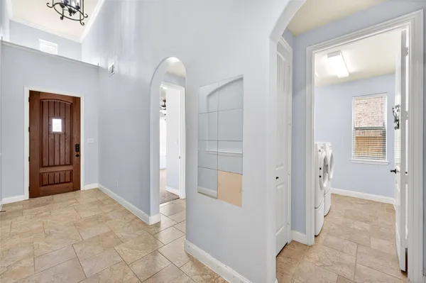 a view of a hallway with wooden floor and a livingroom