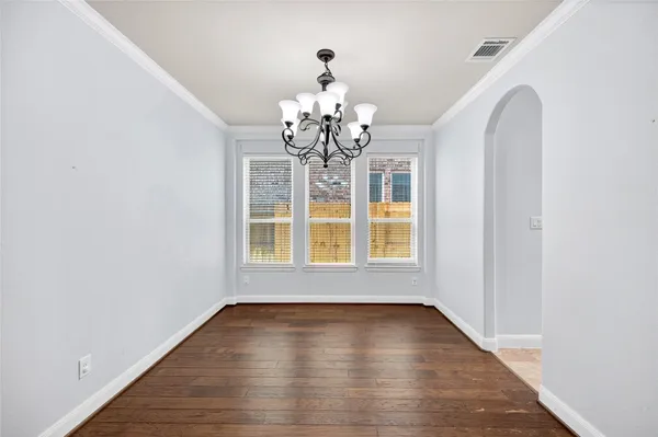 a view of wooden floor and a chandelier in a room
