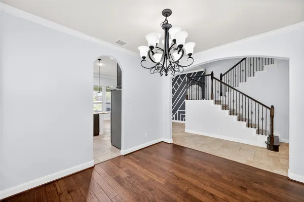 a view of entryway and hall with wooden floor