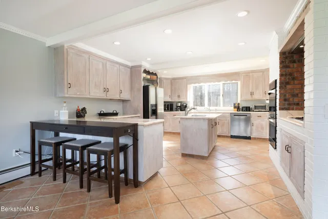 a kitchen with a sink counter top space appliances and cabinets