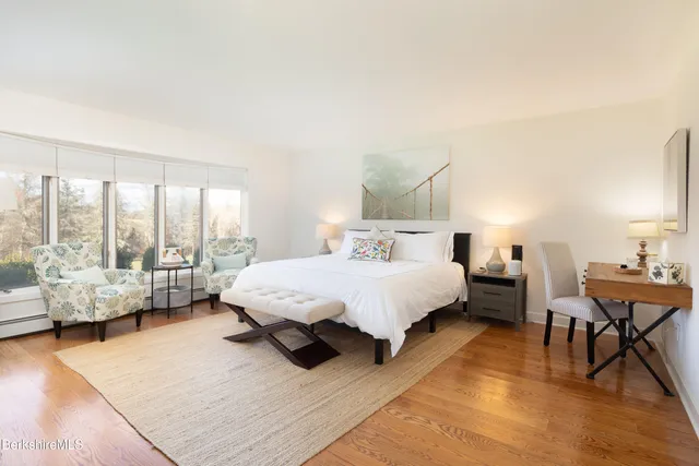 a spacious bedroom with a bed and a couch