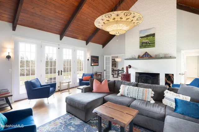 a living room with furniture a fireplace and a large window