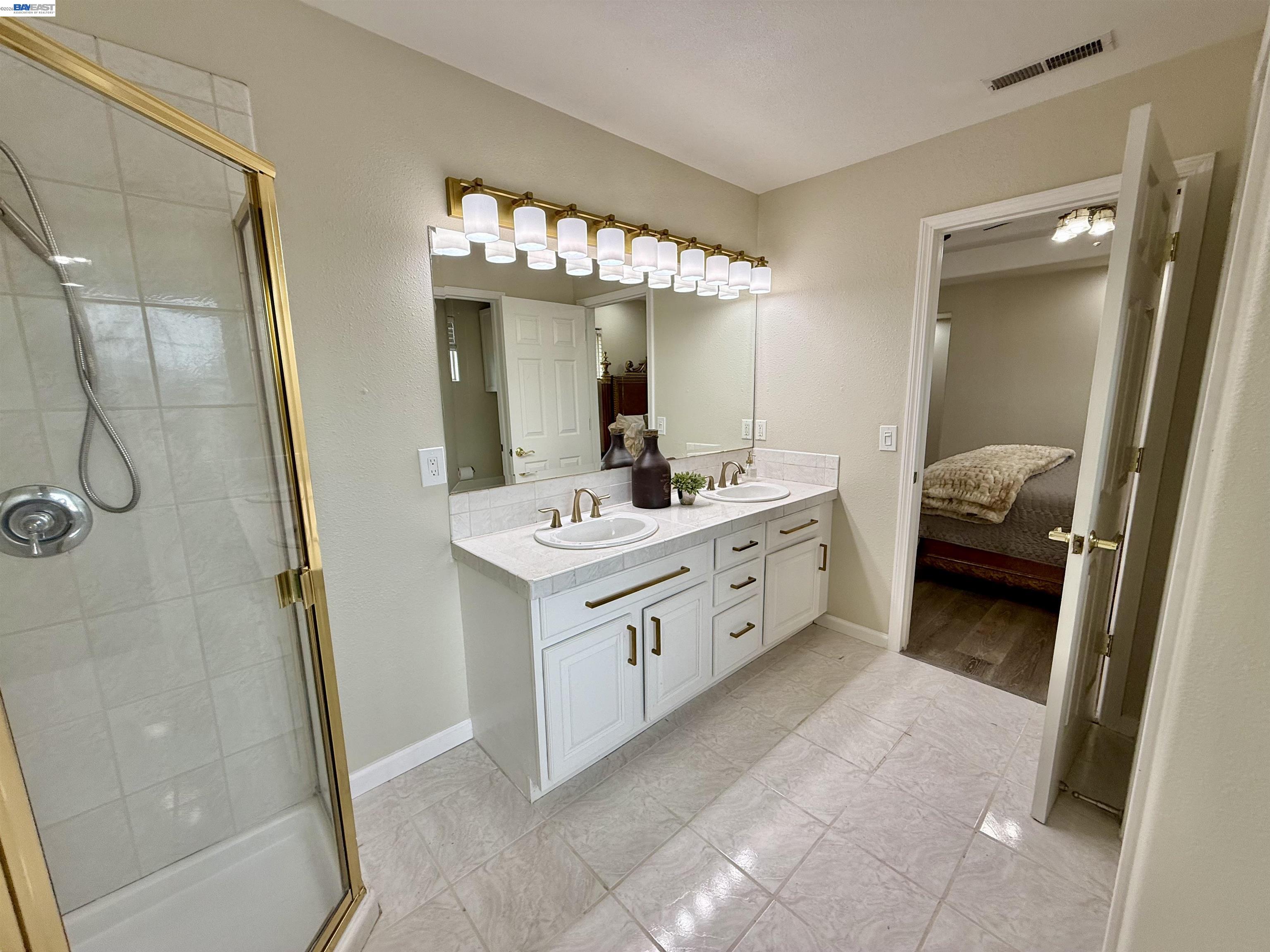 1284 Riesling Circle Livermore, CA 94550 - Photo 53 of 79 a bathroom with a double vanity sink a mirror and a shower