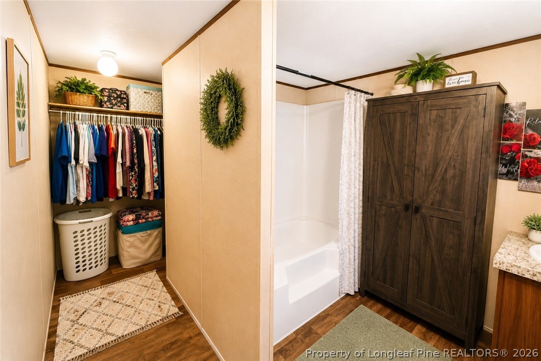 466 Ralph Hunt Boulevard Orrum, NC 28369 - Photo 8 of 17 a view of walk in closet with clothes and shoes