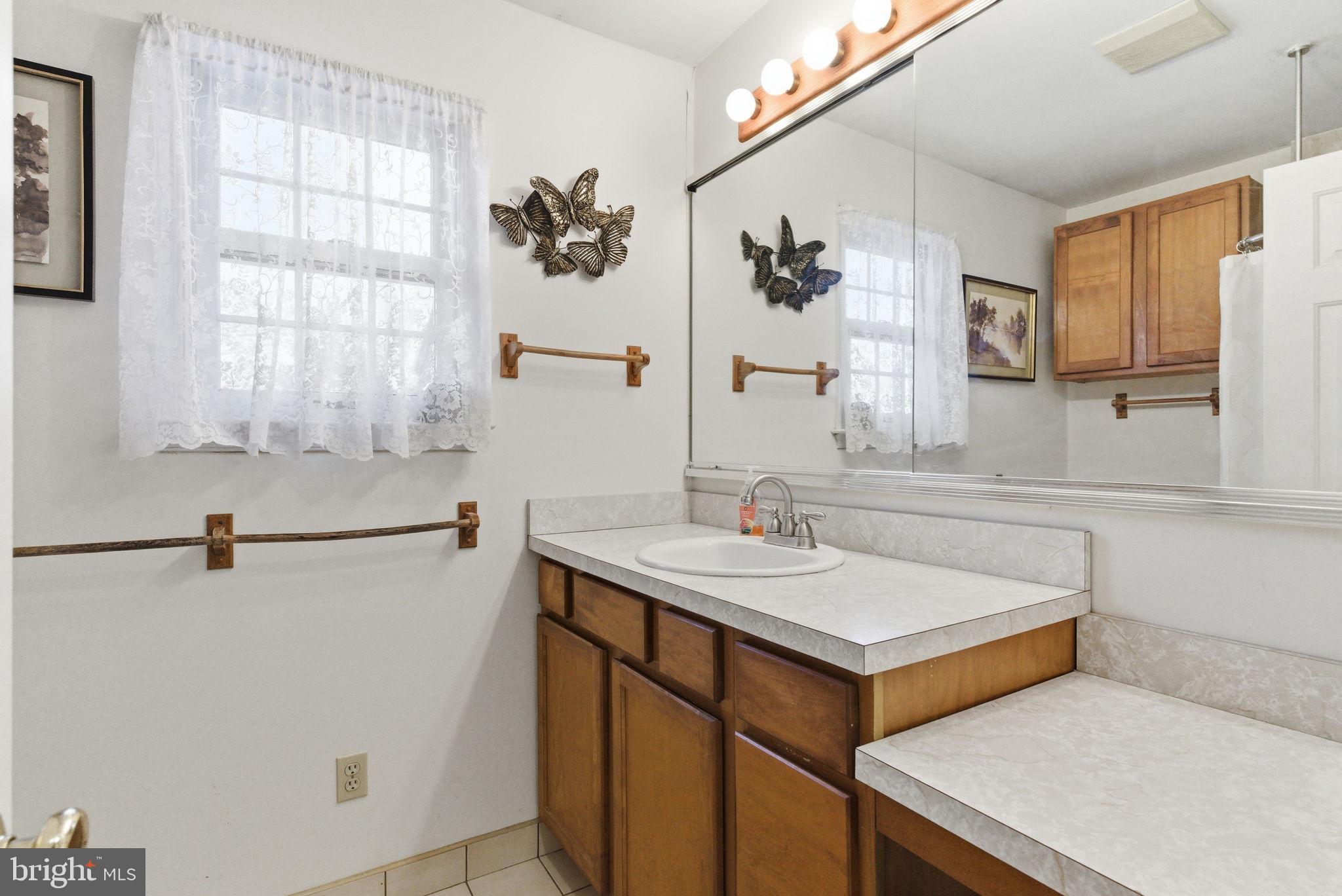 416 Rices Mill Road Wyncote, PA 19095 - Photo 27 of 60 a bathroom with a sink and a mirror