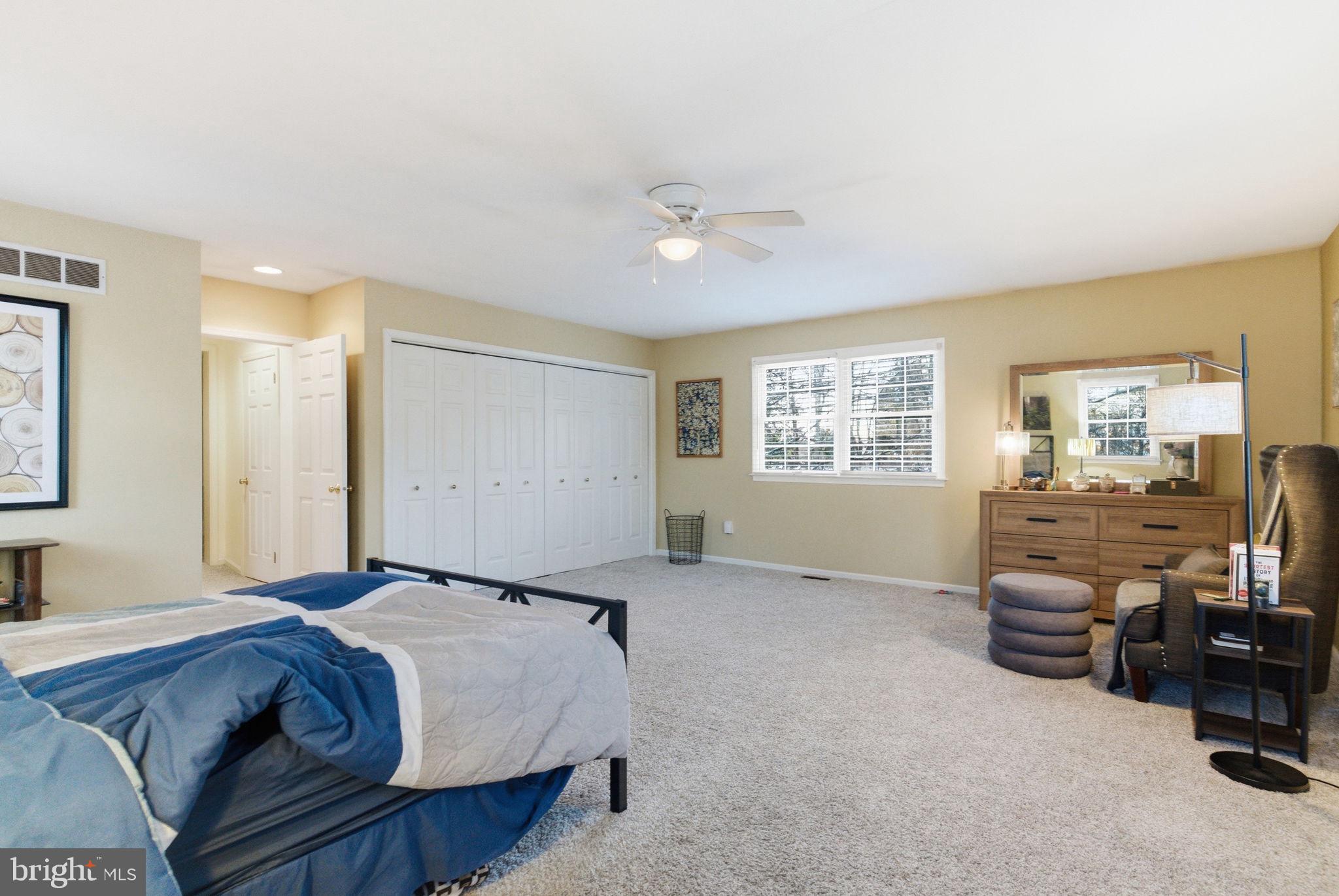 416 Rices Mill Road Wyncote, PA 19095 - Photo 31 of 60 a spacious bedroom with a bed and a chandelier