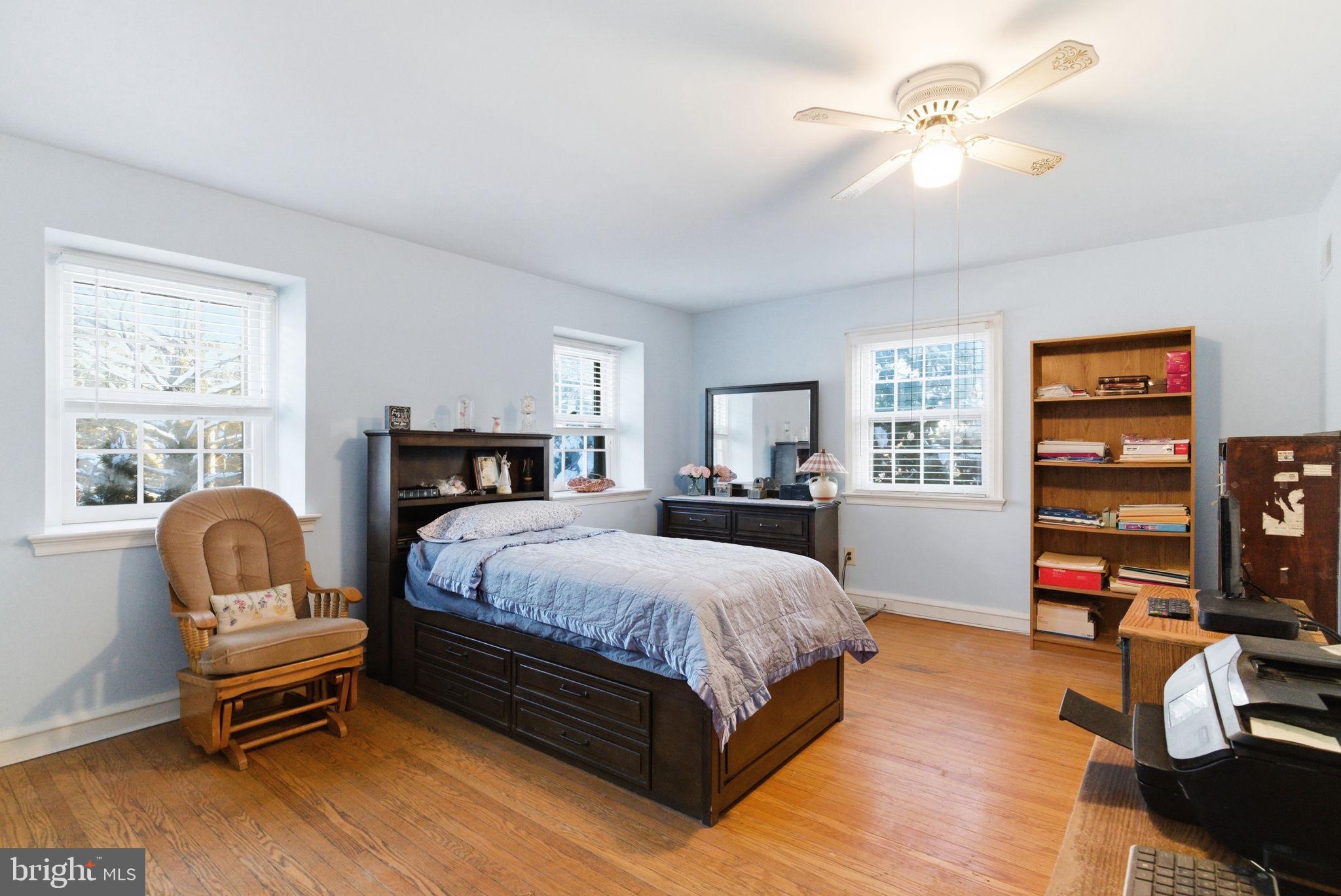 416 Rices Mill Road Wyncote, PA 19095 - Photo 33 of 60 a bedroom with a bed wooden floor and a window