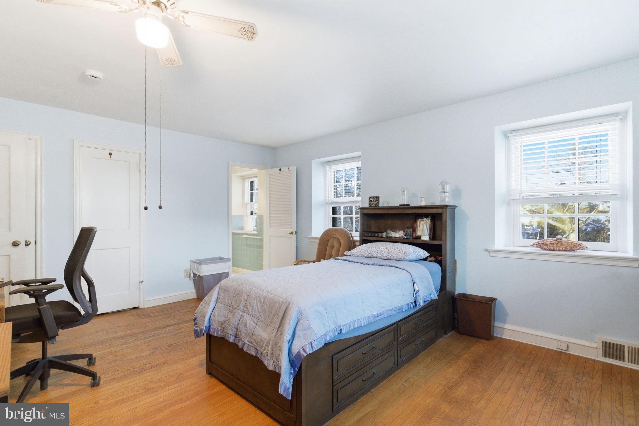 416 Rices Mill Road Wyncote, PA 19095 - Photo 34 of 60 a bedroom with a bed a chair and potted plant on the dresser