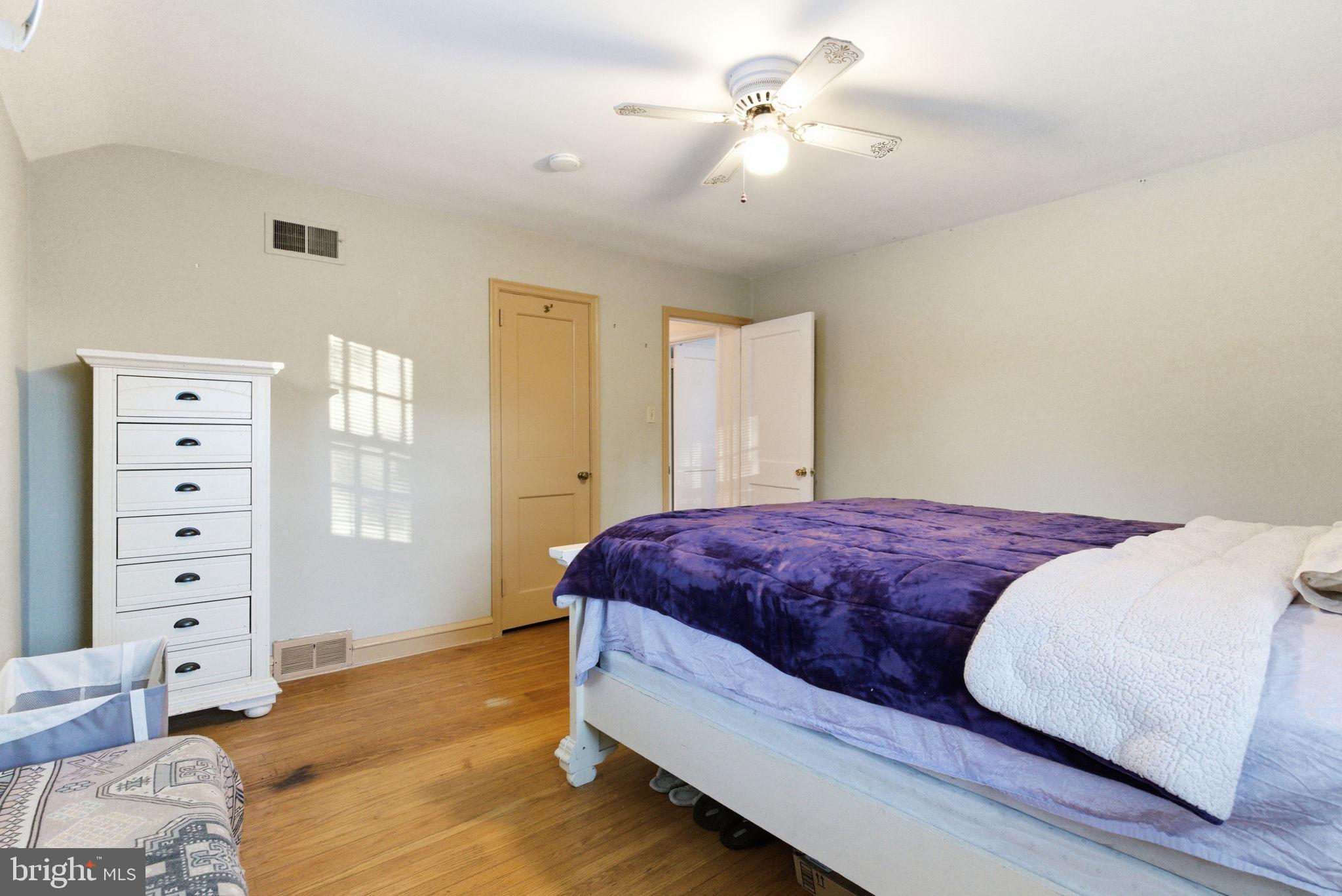 416 Rices Mill Road Wyncote, PA 19095 - Photo 39 of 60 a bedroom with a bed and a chandelier