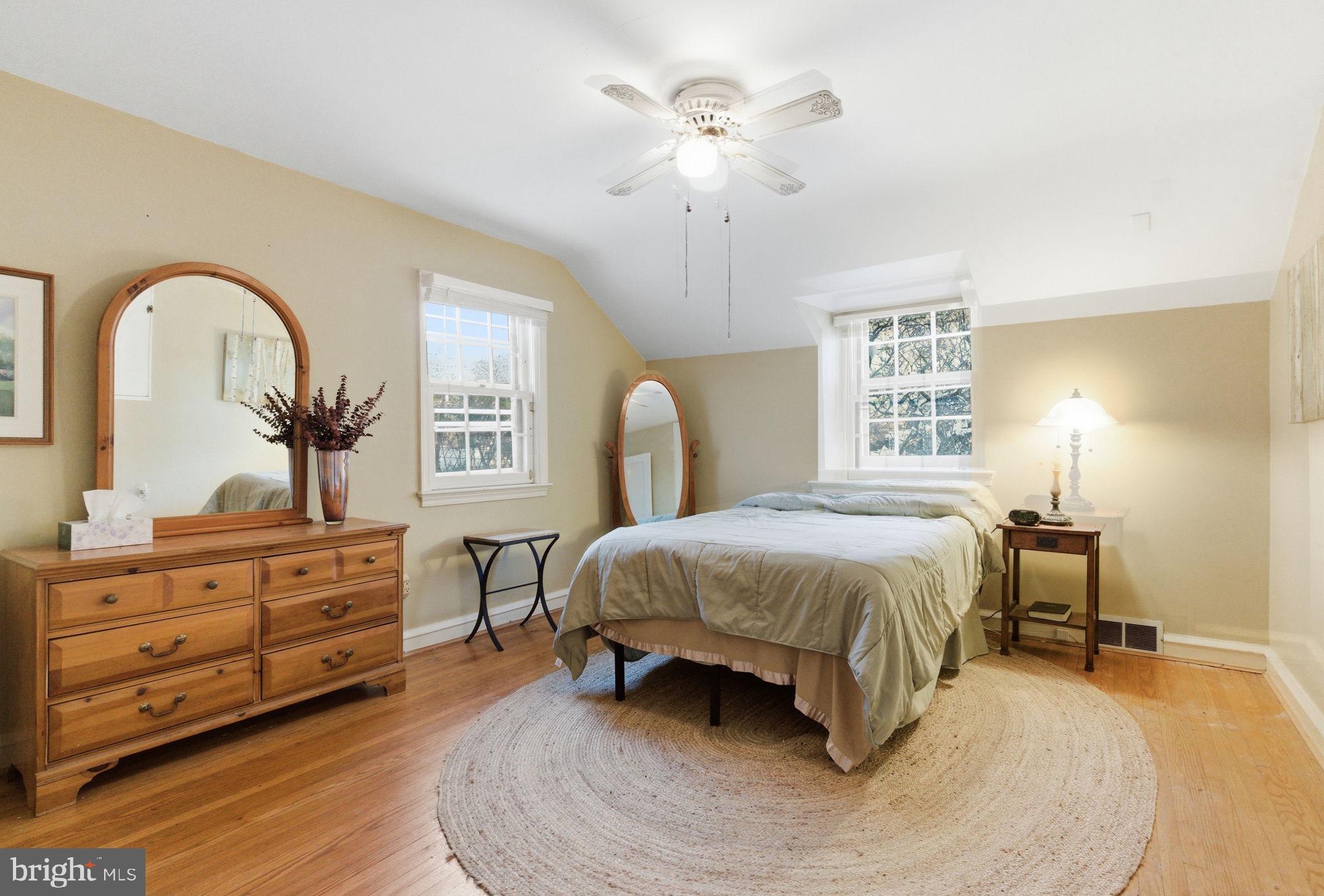 416 Rices Mill Road Wyncote, PA 19095 - Photo 42 of 60 a spacious bedroom with a bed a chandelier and dresser