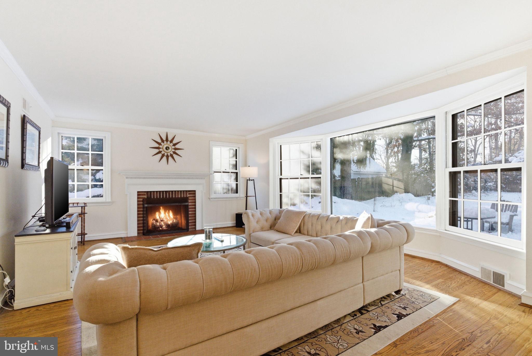 416 Rices Mill Road Wyncote, PA 19095 - Photo 6 of 60 a living room with furniture a flat screen tv and a fireplace