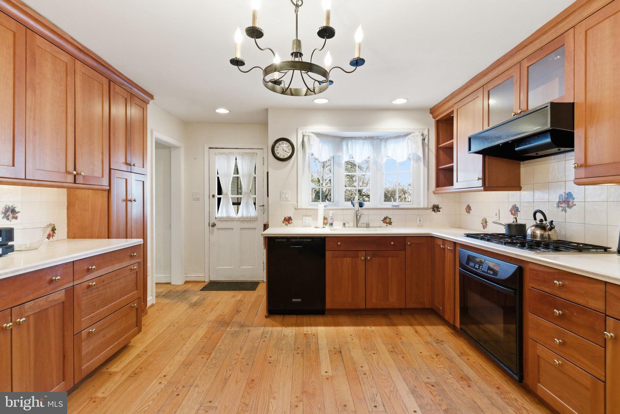 416 Rices Mill Road Wyncote, PA 19095 - Photo 9 of 60 a kitchen with stainless steel appliances granite countertop a sink cabinets and wooden floor